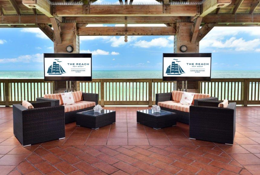 Screens behind couches in the gazebo overlooking the ocean